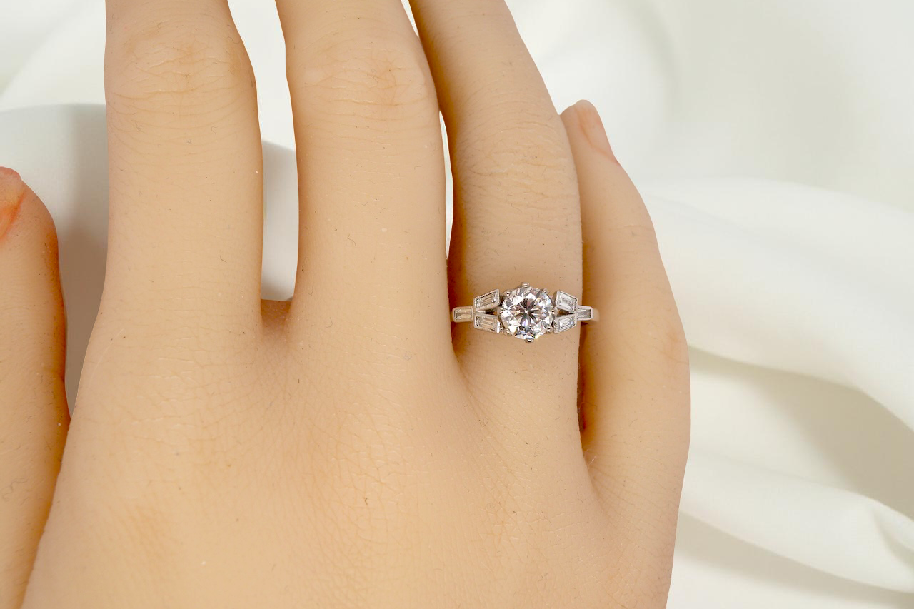 hand A beautifully proportioned Art Deco solitaire ring showcasing a sparkling old brilliant cut white diamond