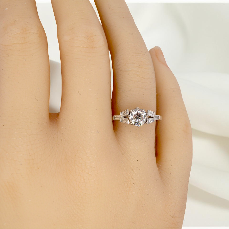 hand A beautifully proportioned Art Deco solitaire ring showcasing a sparkling old brilliant cut white diamond