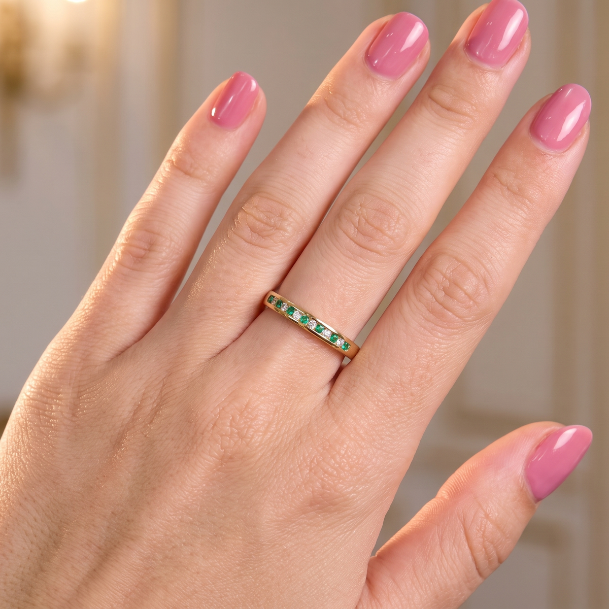 hand A brand new half hoop eternity ring. Set with eight 1.3mm emeralds (total 0.12 carats) and interspaced with brilliant cut white diamonds, each 1.3mm (0.10 carats)