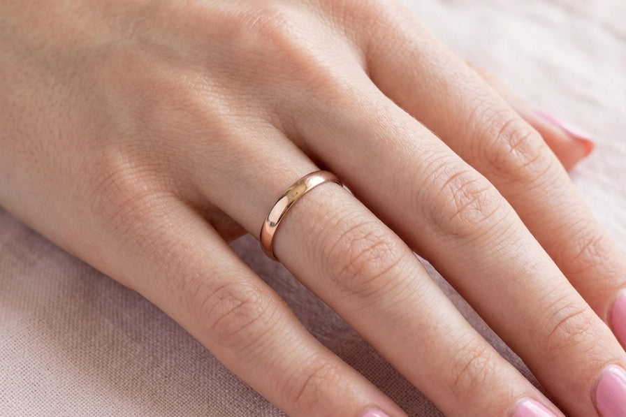 hand A classic 18 carat rose gold wedding ring.
Plain polished finish, 3.8mm wide. weight 2 grams.