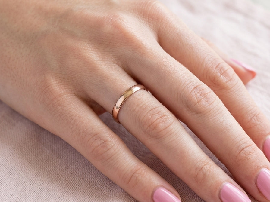 hand A classic 18 carat rose gold wedding ring.
Plain polished finish, 3.8mm wide. weight 2 grams.