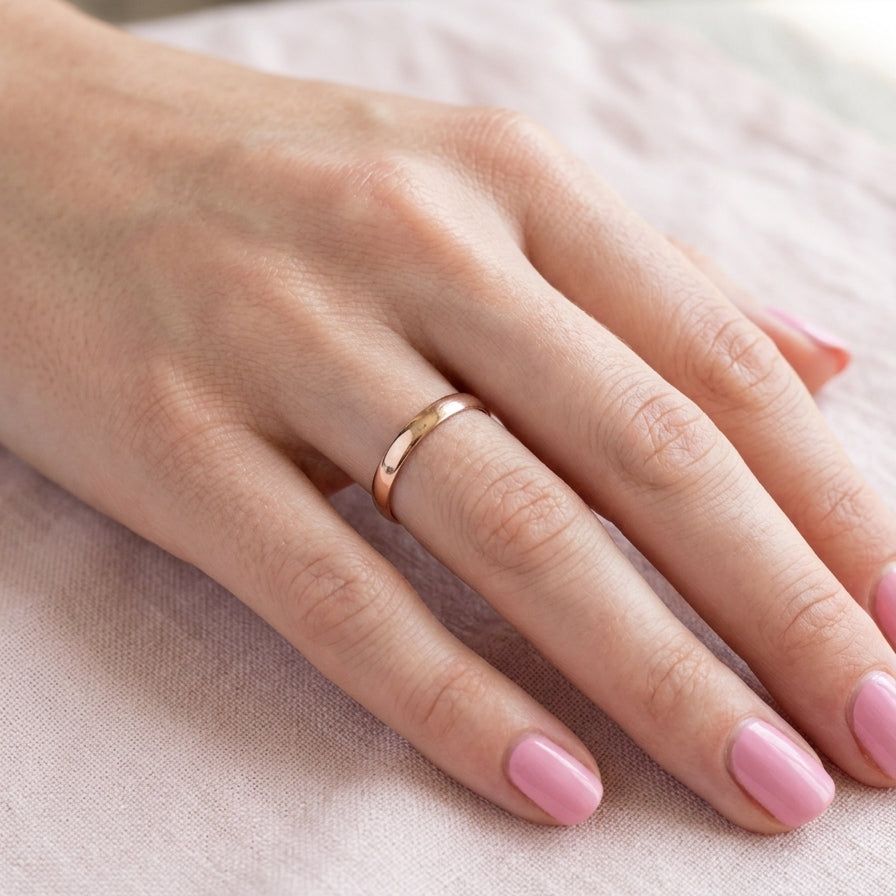 hand A classic 18 carat rose gold wedding ring.
Plain polished finish, 3.8mm wide. weight 2 grams.