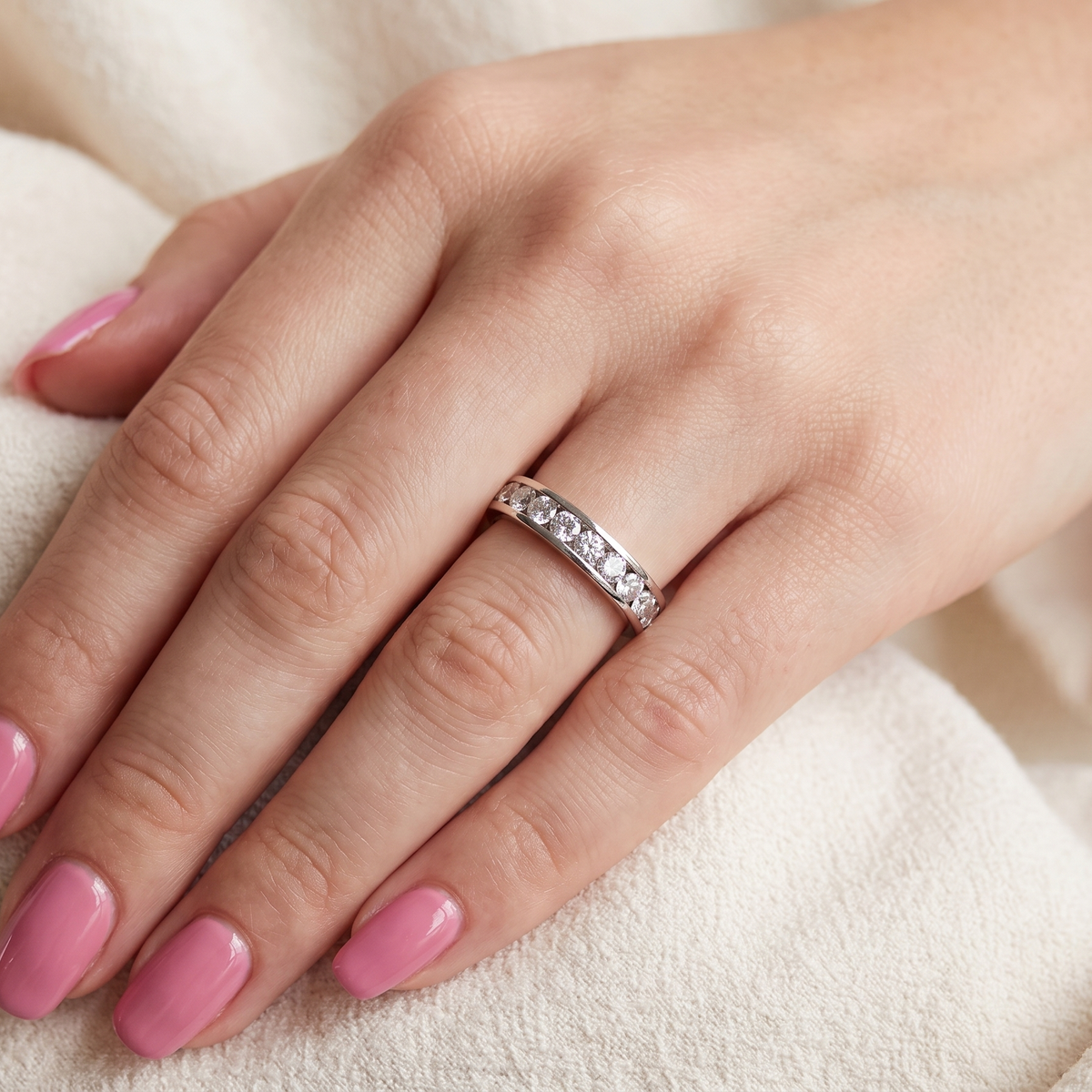 hand A classic 18 carat white gold half hoop diamond eternity ring, beautifully set with ten brilliant cut white diamonds.