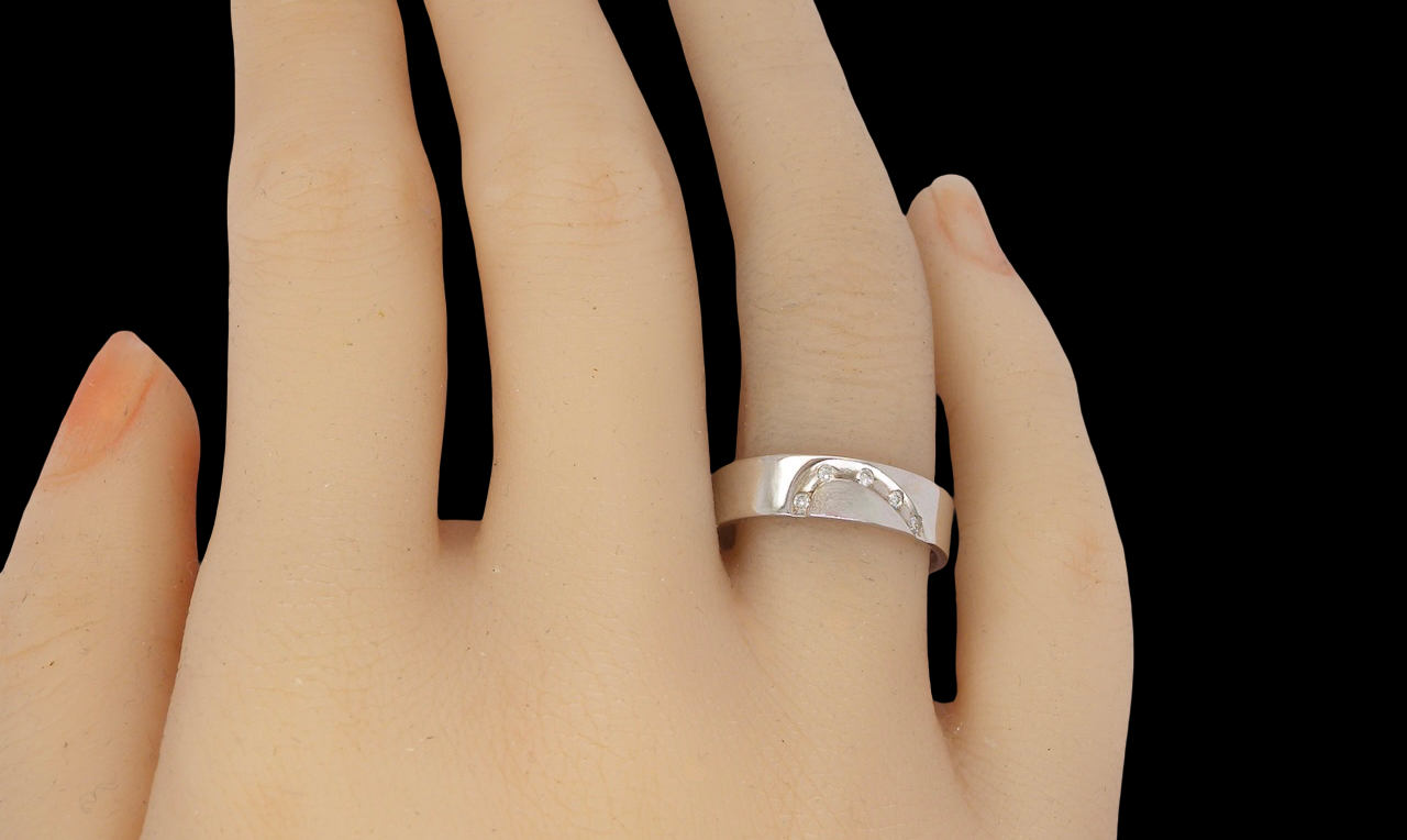 hand A classic 9 carat white gold ring with a timeless wedding-band style, equally suited to wear as a simple diamond dress ring.