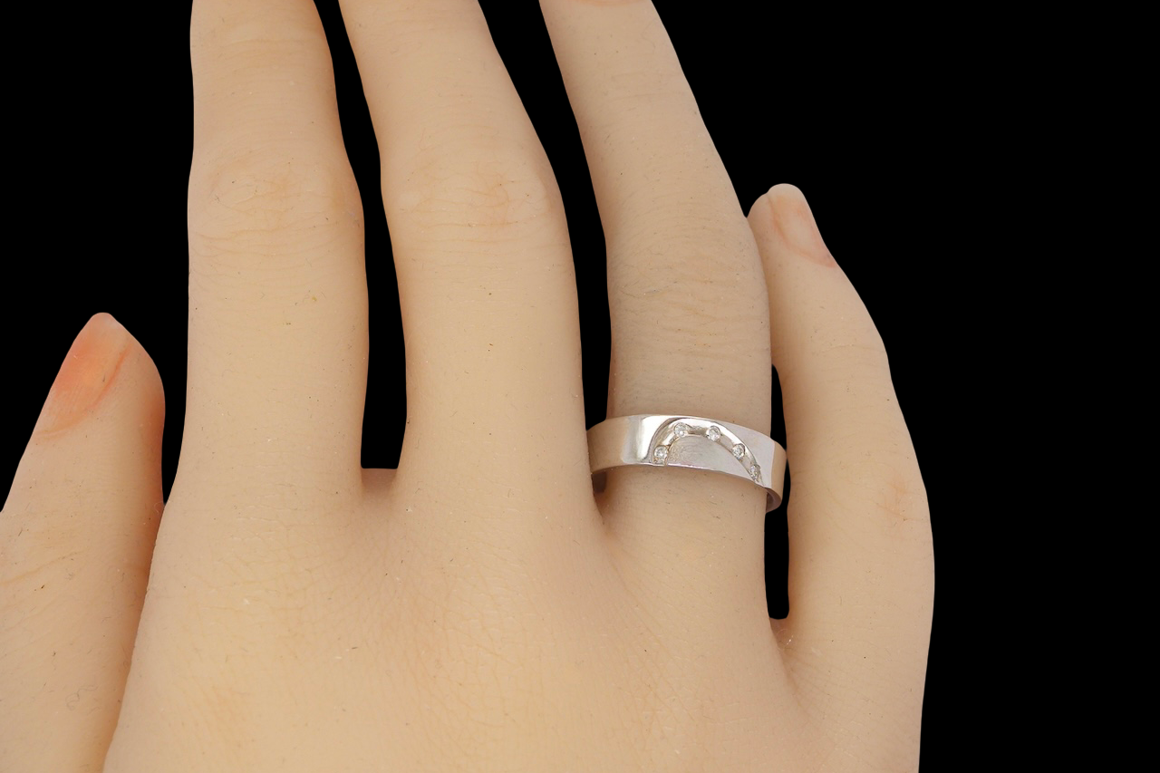 hand A classic 9 carat white gold ring with a timeless wedding-band style, equally suited to wear as a simple diamond dress ring.