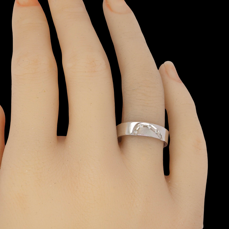 hand A classic 9 carat white gold ring with a timeless wedding-band style, equally suited to wear as a simple diamond dress ring.