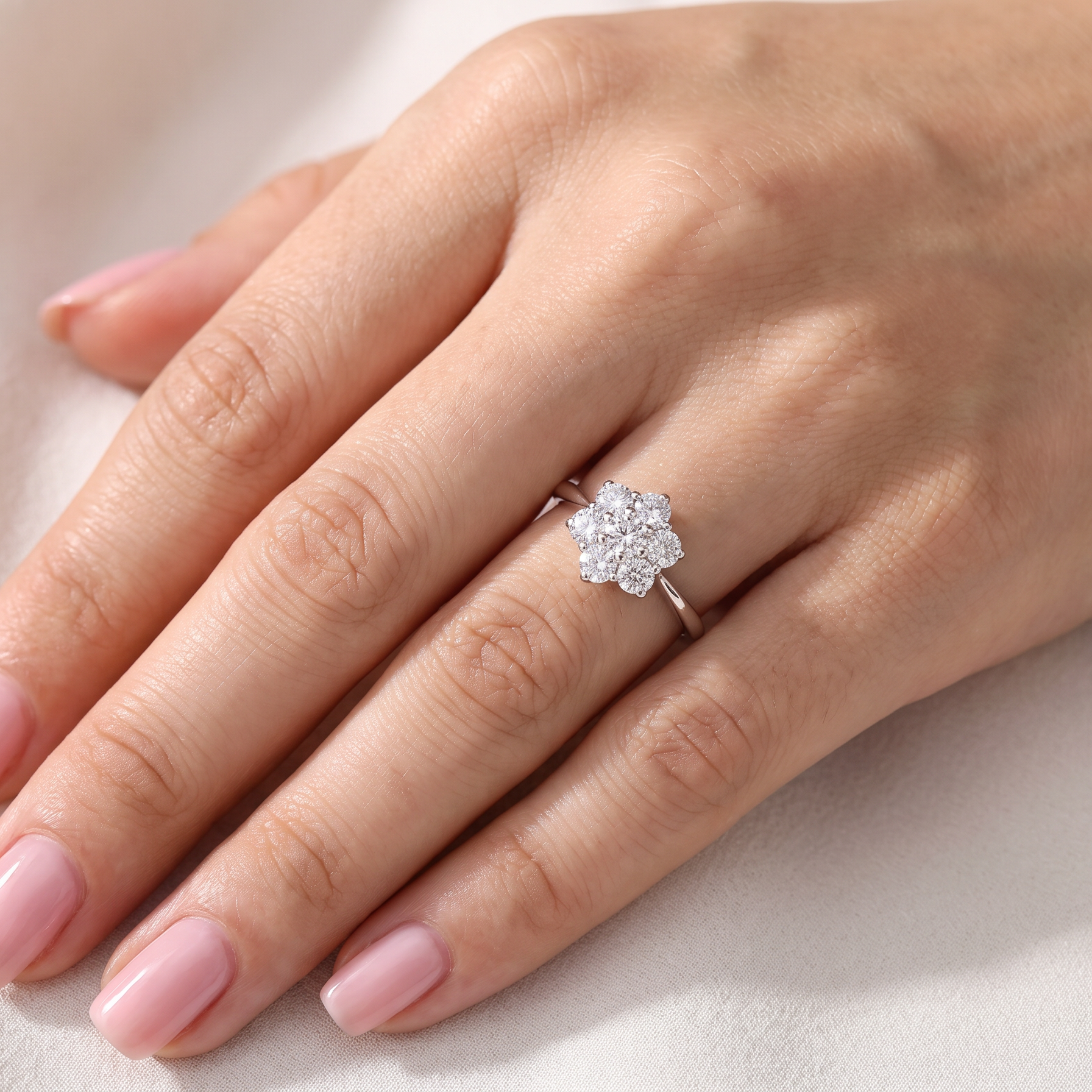 hand A fabulous vintage diamond cluster ring, beautifully crafted in 18 carat white gold and set with seven fine brilliant cut white diamonds.