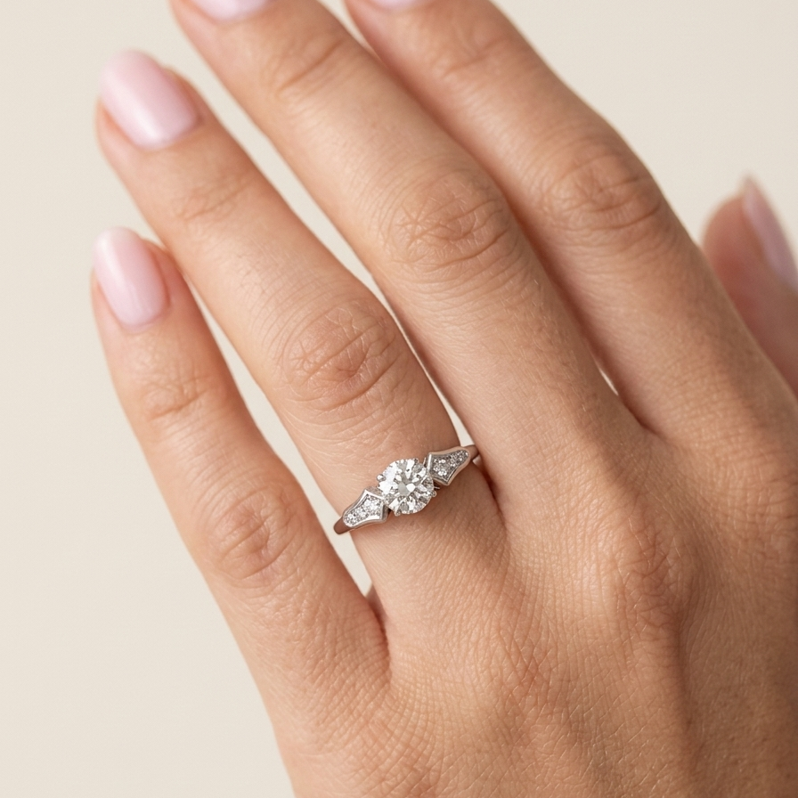 hand A fine solitaire ring featuring an e lovely brilliant cut white diamond. Measures 6.3mm (est 0.85 carats) very bright white stone, colour H-i, clarity VS. Head depth 7mm. 