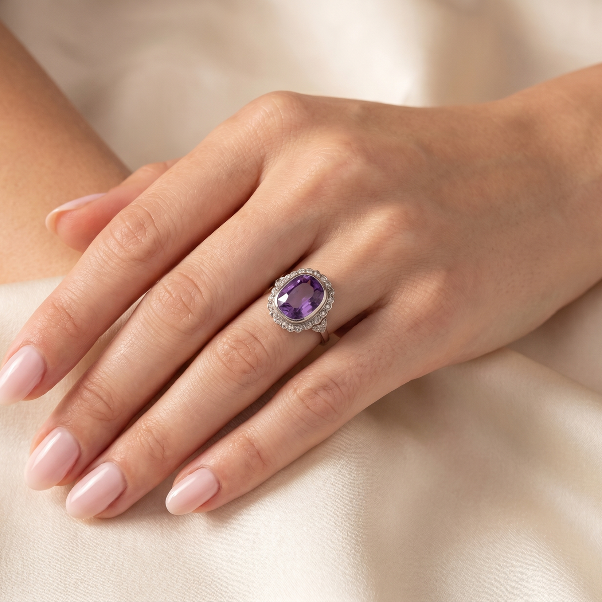 hand A fine vintage ring. Features to the centre a large cushion shaped amethyst, 13x10mm, rim setting.