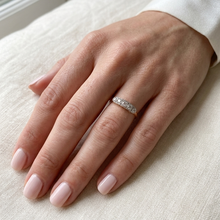 hand A fine vintage ring set with five brilliant cut white diamonds.
Centre diamond 3.6mm (est 0.15 carats)