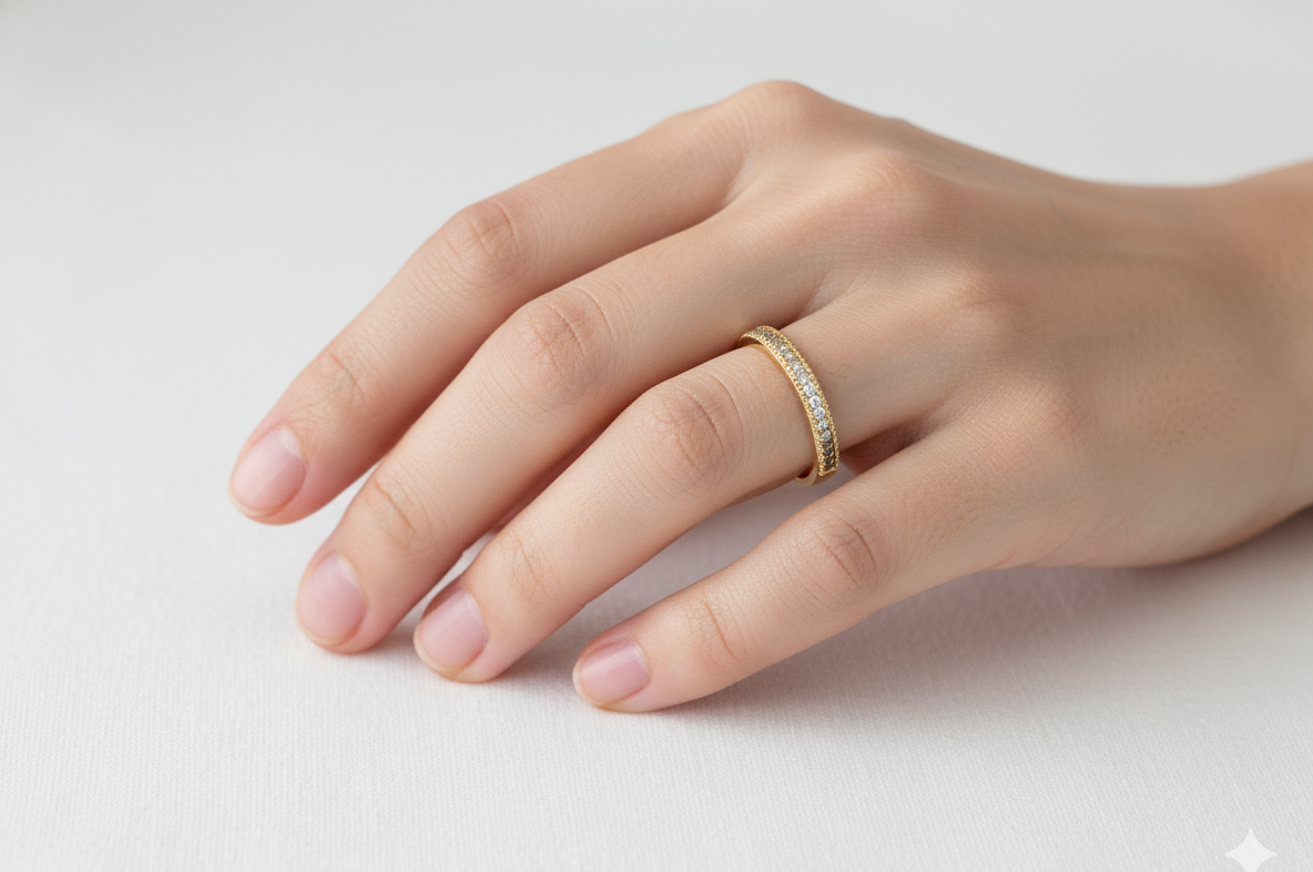 hand A half-hoop eternity ring set with approximately twenty-four white diamonds