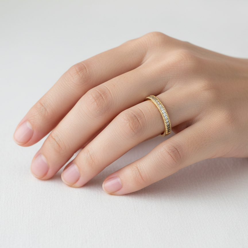 hand A half-hoop eternity ring set with approximately twenty-four white diamonds