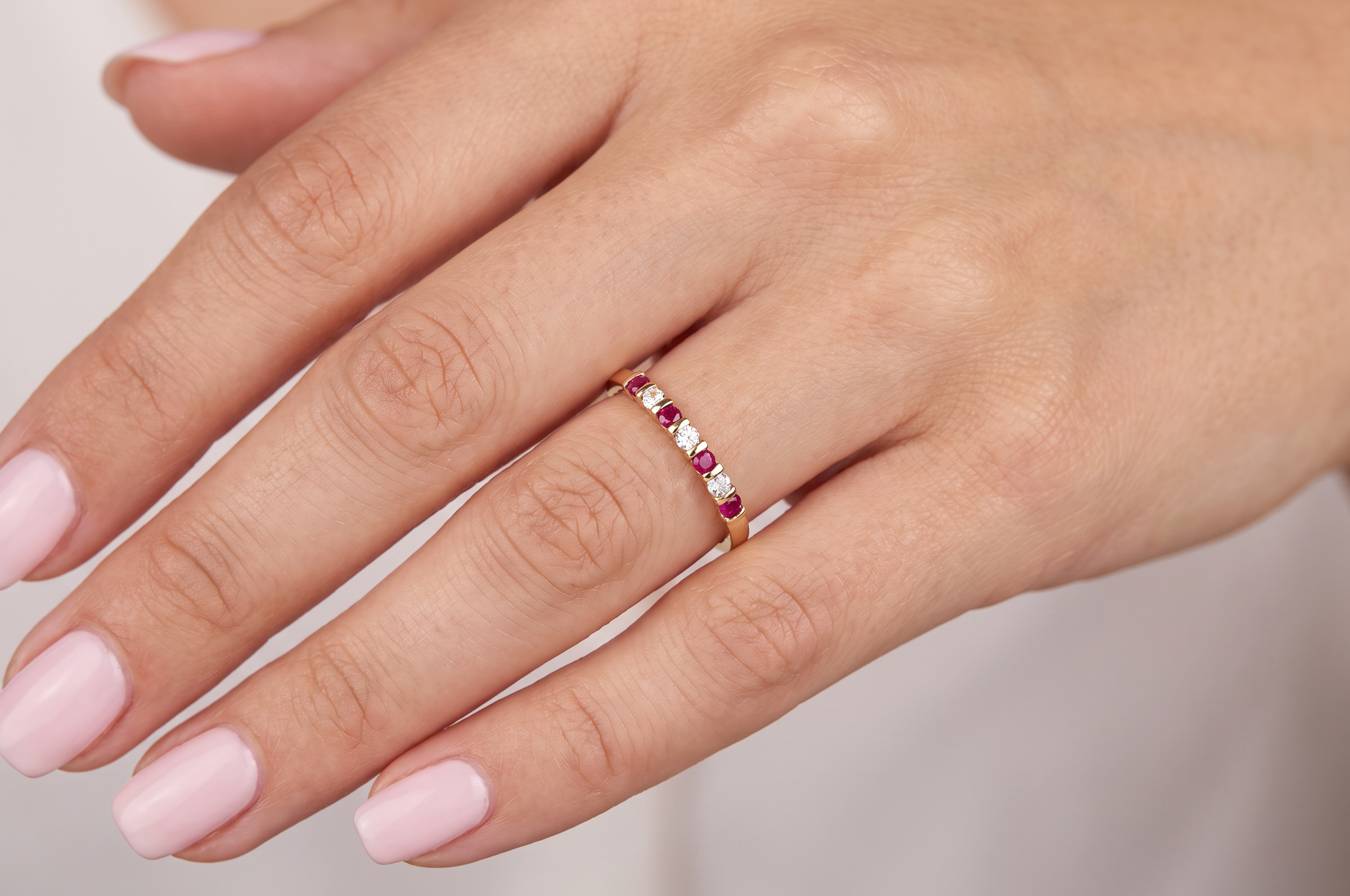 hand A half hoop 18 carat yellow gold eternity ring. Set with four bright red rubies, each 2.6mm (total carat weight 0.28 est)