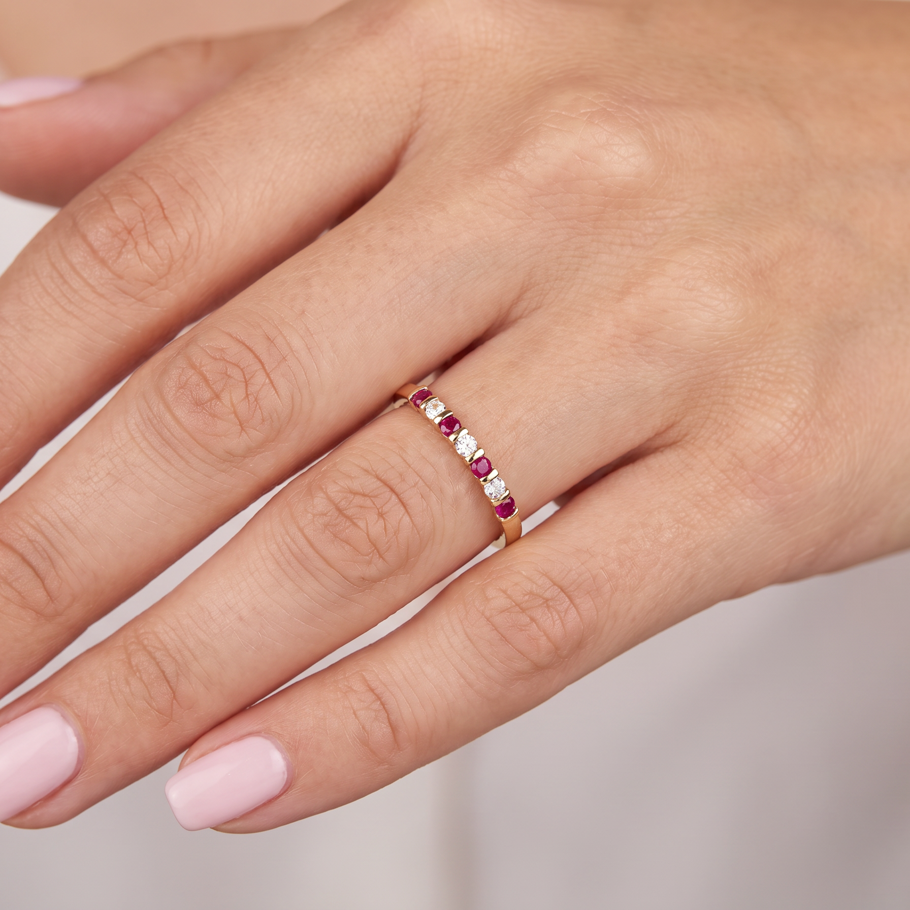 hand A half hoop 18 carat yellow gold eternity ring. Set with four bright red rubies, each 2.6mm (total carat weight 0.28 est)