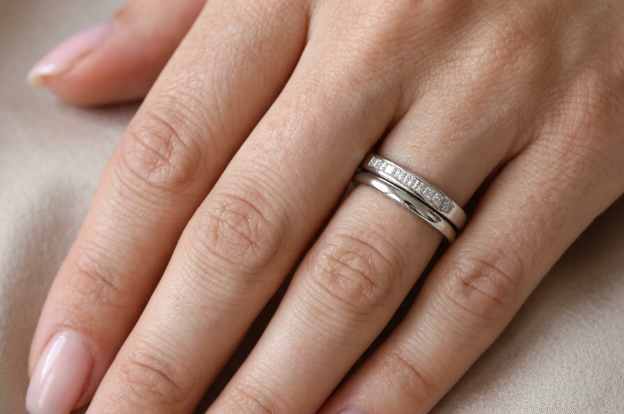 hand A half hoop 9 carat white gold eternity ring.
Channel set with eleven Princess cut white diamonds,