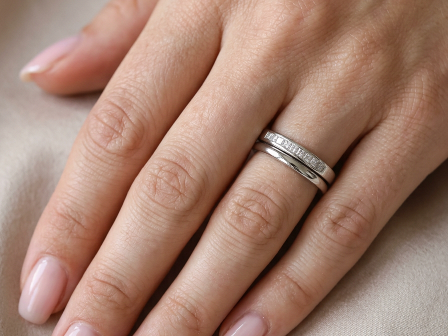 hand A half hoop 9 carat white gold eternity ring.
Channel set with eleven Princess cut white diamonds,