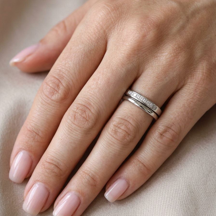 hand A half hoop 9 carat white gold eternity ring.
Channel set with eleven Princess cut white diamonds,
