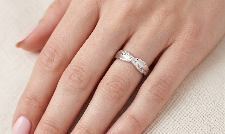 hand A half hoop 9 carat white gold eternity ring. Set with five small white diamonds, each 1.3mm (total 0.05 carats)