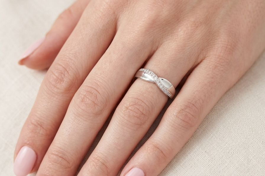 hand A half hoop 9 carat white gold eternity ring. Set with five small white diamonds, each 1.3mm (total 0.05 carats)