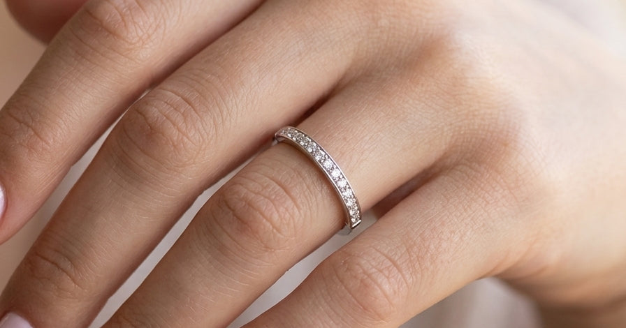 hand A half hoop eternity ring. Set with eleven small white diamonds, brilliant cut 2mm each (total est 0.33 carats) colour i-k, clarity Si.