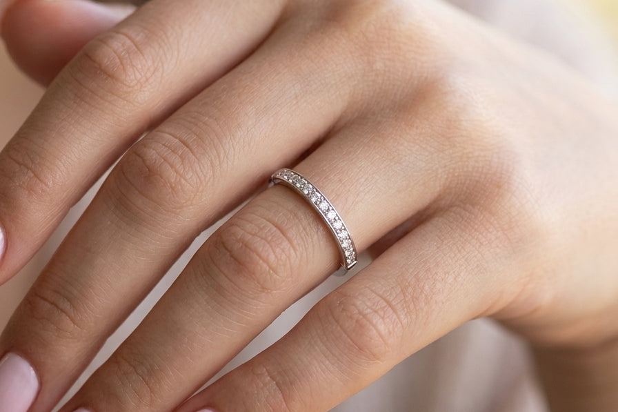 hand A half hoop eternity ring. Set with eleven small white diamonds, brilliant cut 2mm each (total est 0.33 carats) colour i-k, clarity Si.