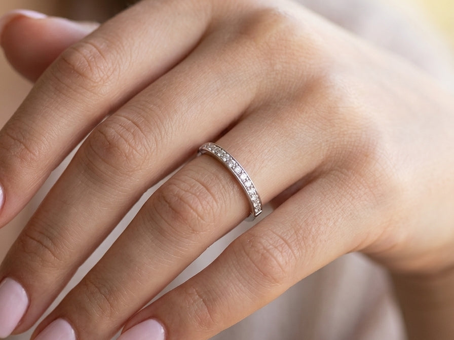 hand A half hoop eternity ring. Set with eleven small white diamonds, brilliant cut 2mm each (total est 0.33 carats) colour i-k, clarity Si.