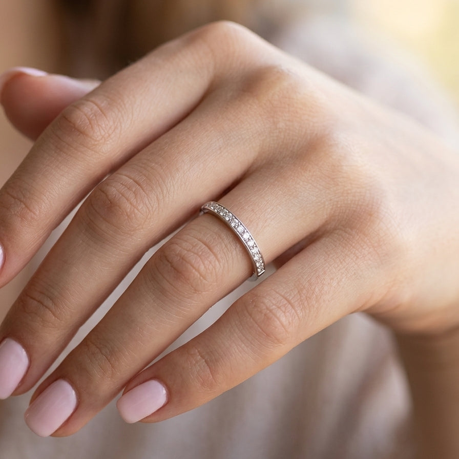 hand A half hoop eternity ring. Set with eleven small white diamonds, brilliant cut 2mm each (total est 0.33 carats) colour i-k, clarity Si.