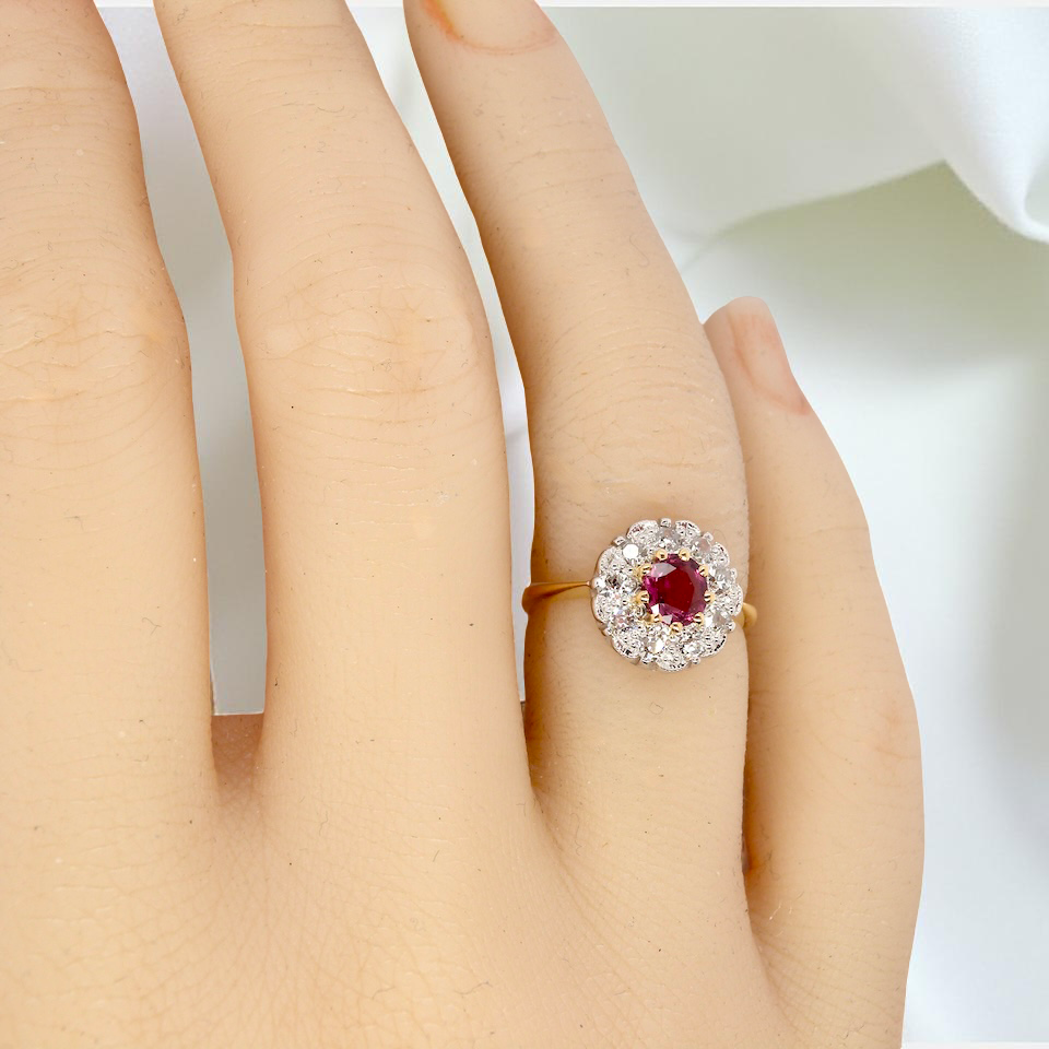 hand A lovely daisy cluster ring that profiles to the centre a deep red ruby, 5mm (0.50 carats) yellow claw set.