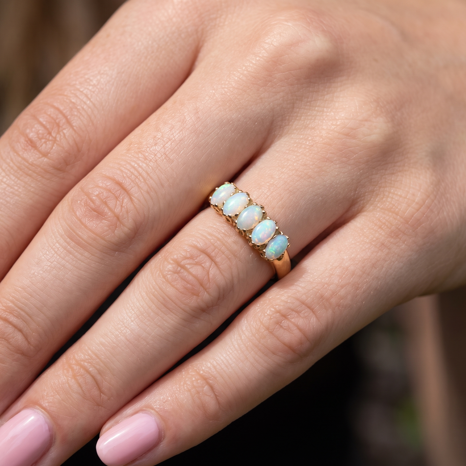 hand A lovely five stone ring. Set with five oval white opals, each 5x3.5mm, good play of colour on all.
Carved head