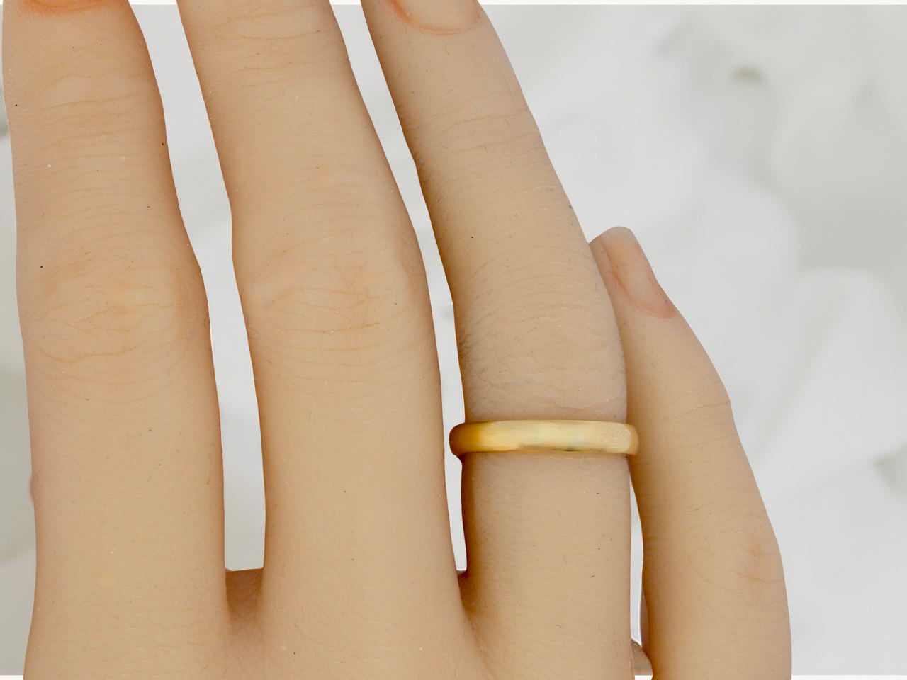 A narrow 18 carat gold wedding ring