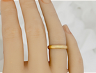 A narrow 18 carat gold wedding ring