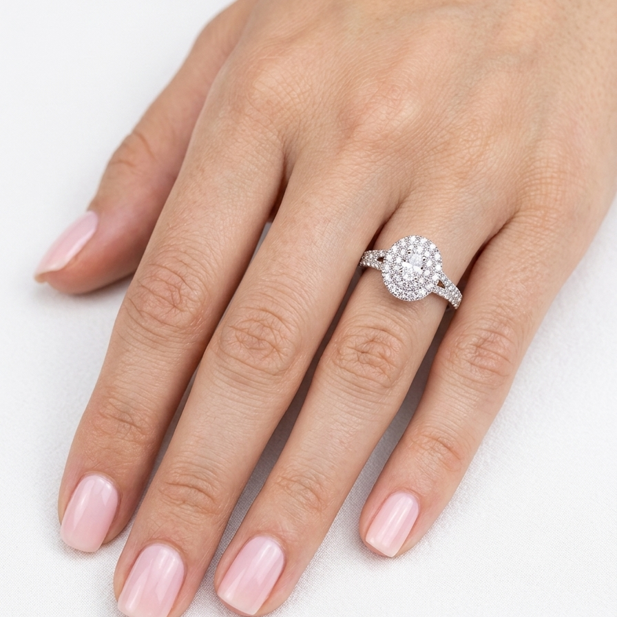 hand A new diamond cluster ring* An oval diamond halo cluster ring. Set with brilliant cut white diamonds, colour H-k, clarity Si.