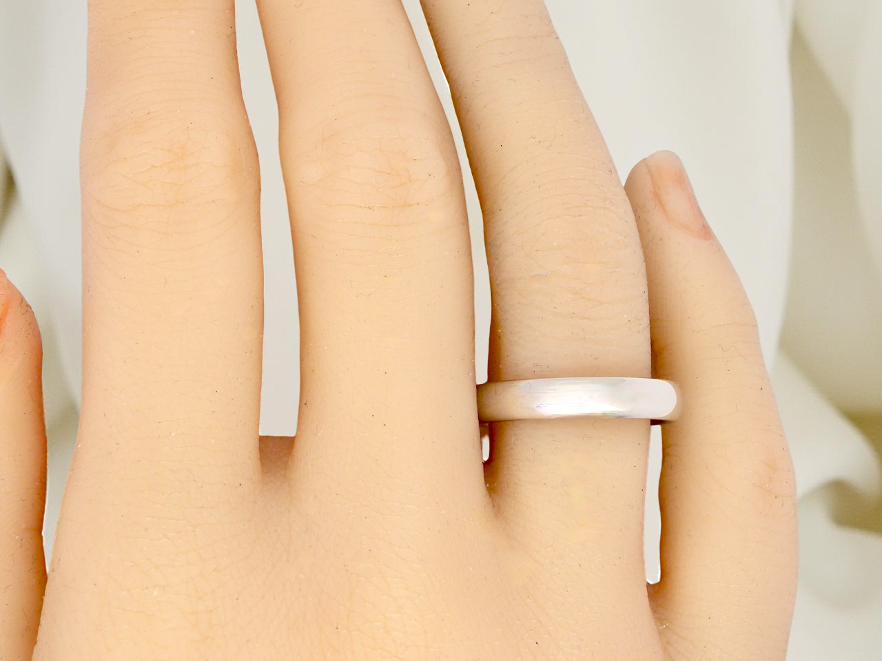 A plain 18 carat white gold wedding ring