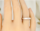 A plain 18 carat white gold wedding ring