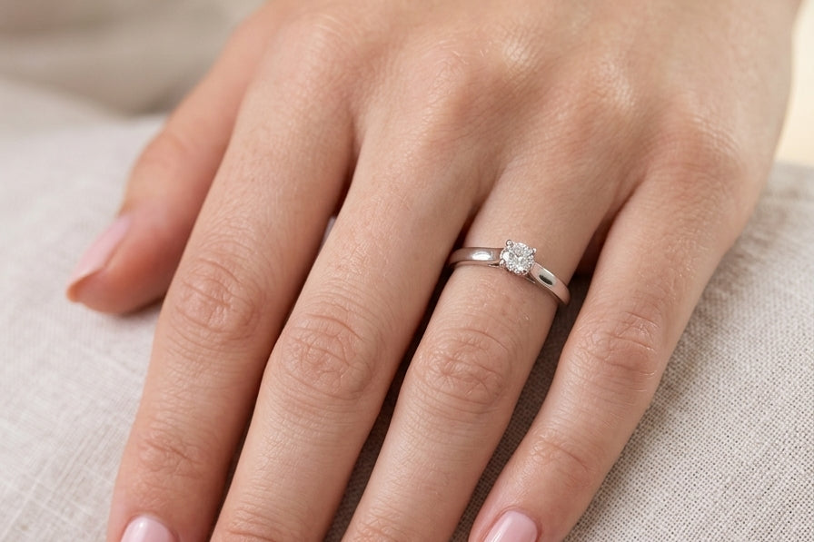 hand A single stone solitaire diamond ring. The modern brilliant cut white diamond measures 3.9mm (0.22 carats est) Colour G-h, clarity VS.