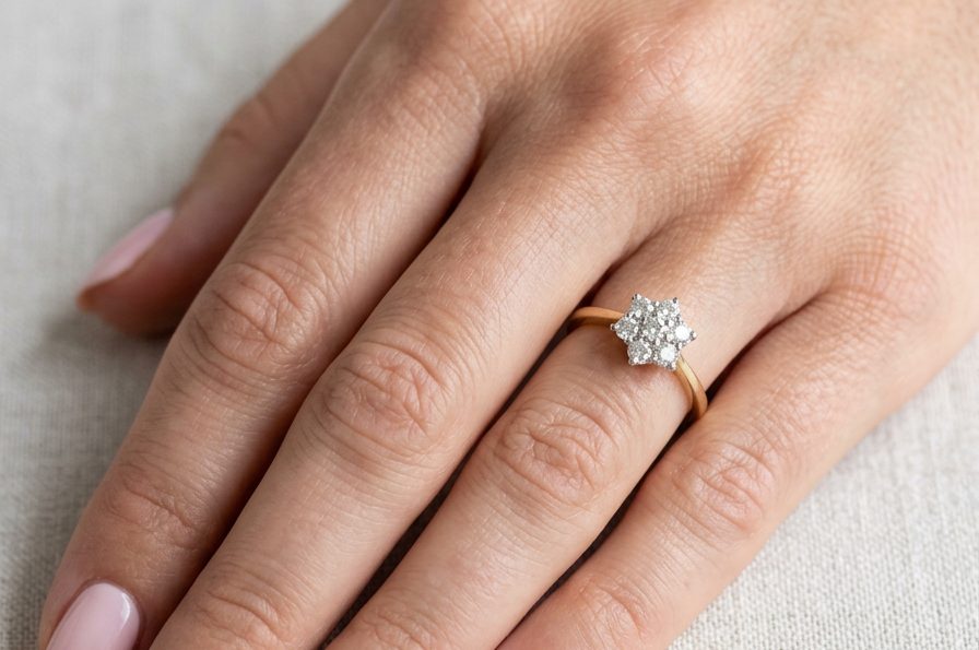 hand A small cluster ring set with seven bright white brilliant cut white diamonds.
Head measures 8.5mm, each diamond measures 2.8mm (total 0.50 carats