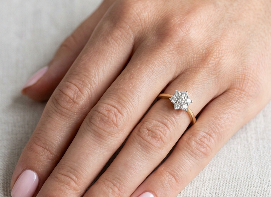 hand A small cluster ring set with seven bright white brilliant cut white diamonds.
Head measures 8.5mm, each diamond measures 2.8mm (total 0.50 carats