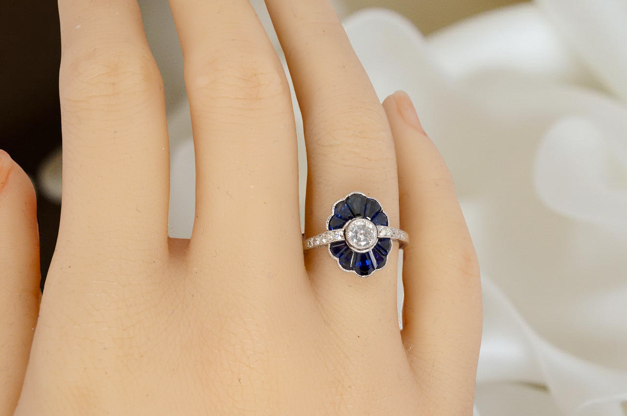 hand A striking and highly unusual Art Deco cluster ring featuring a distinctive fan-shaped design.
