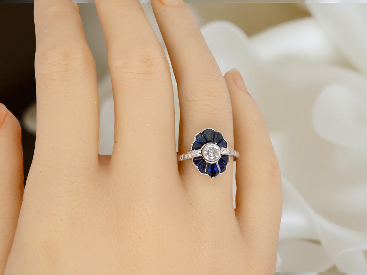 hand A striking and highly unusual Art Deco cluster ring featuring a distinctive fan-shaped design.