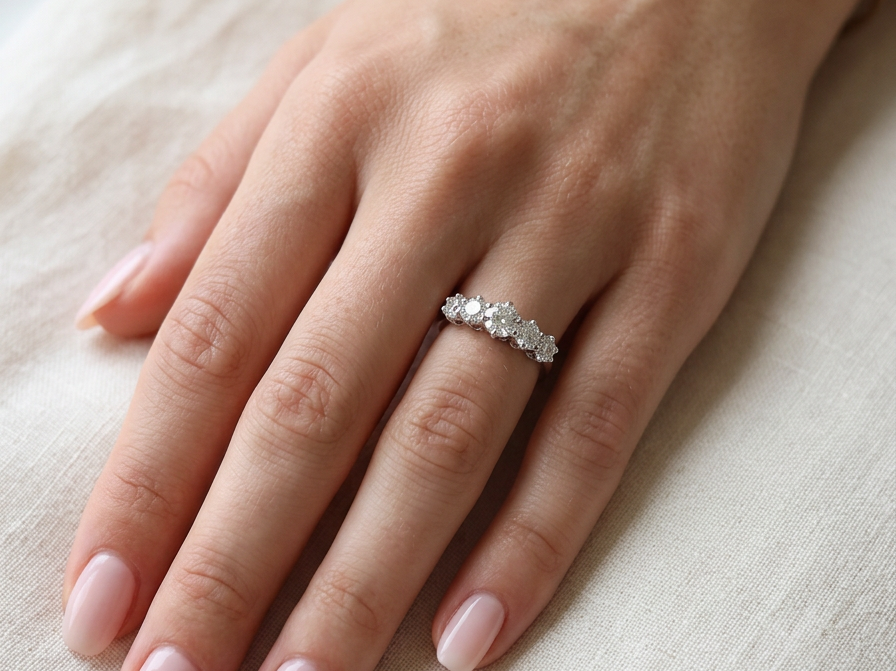 hand A stunning half hoop ring featuring five exceptional brilliant-cut white diamonds, expertly claw set in 18ct white gold.
The centre diamond measures approximately 5.8mm (estimated 0.70 carats), flanked by a 5.0mm diamond on each side, with 4.5mm diamonds at each end.