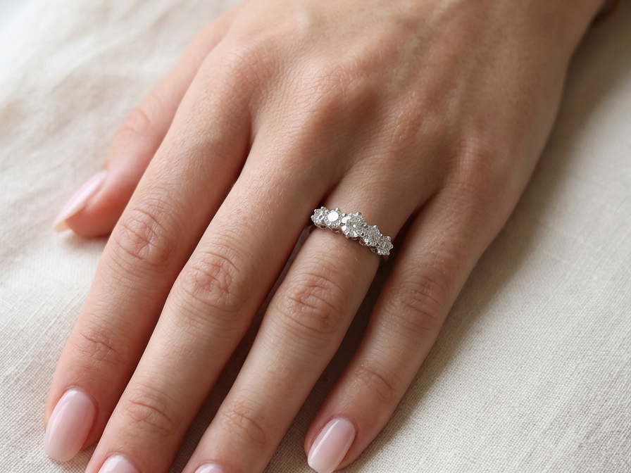 hand A stunning half hoop ring featuring five exceptional brilliant-cut white diamonds, expertly claw set in 18ct white gold.
The centre diamond measures approximately 5.8mm (estimated 0.70 carats), flanked by a 5.0mm diamond on each side, with 4.5mm diamonds at each end.