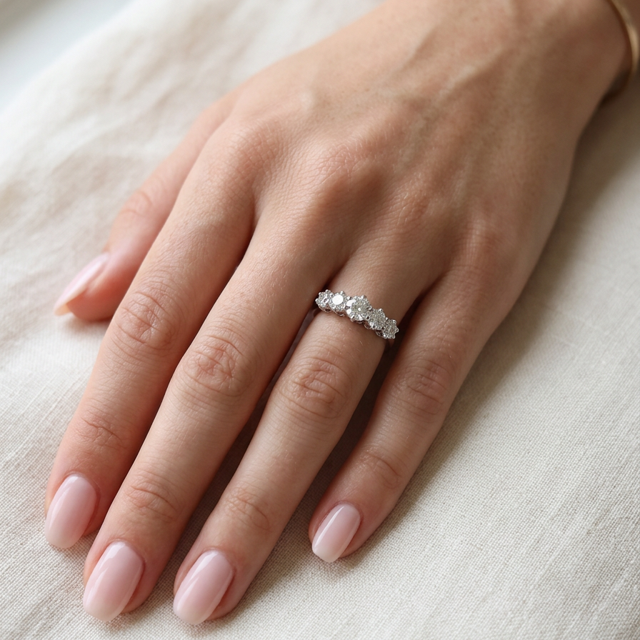 hand A stunning half hoop ring featuring five exceptional brilliant-cut white diamonds, expertly claw set in 18ct white gold.
The centre diamond measures approximately 5.8mm (estimated 0.70 carats), flanked by a 5.0mm diamond on each side, with 4.5mm diamonds at each end.