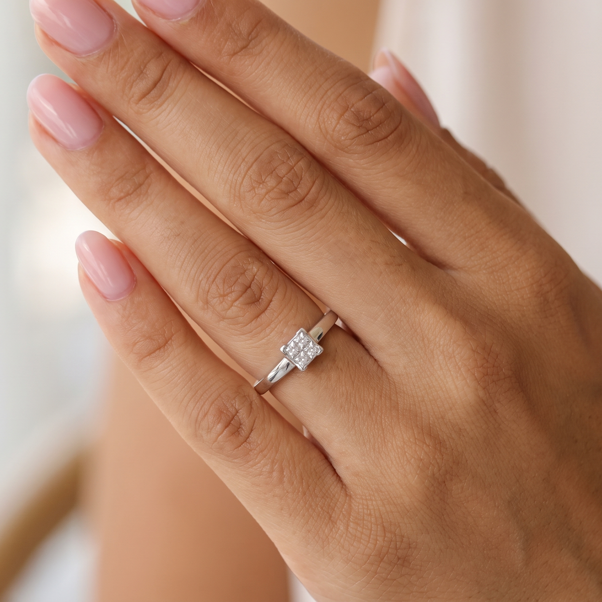 hand A stylish modern 18 carat white gold diamond cluster ring, with a beautifully clean and understated design.
The square-shaped head is set with four Princess cut white diamonds,