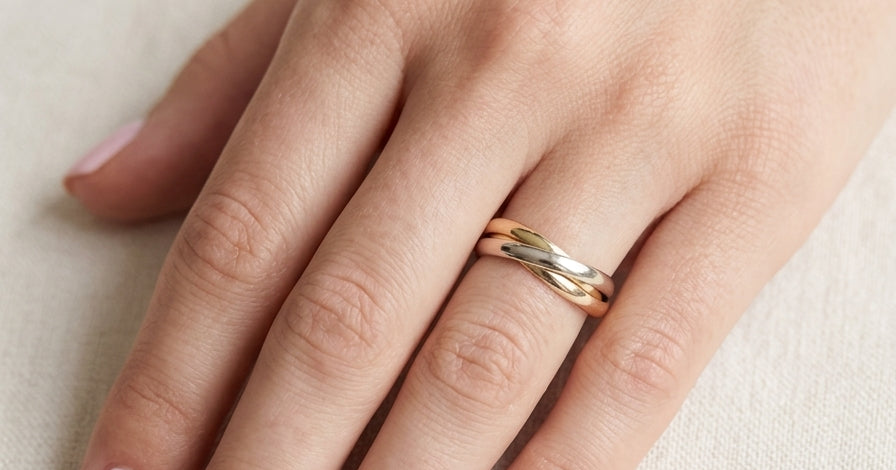 hand A three colour gold ring (AKA Russian wedding ring) Each band just under 3mm wide, D shape profile.
Yellow, white and rose gold,