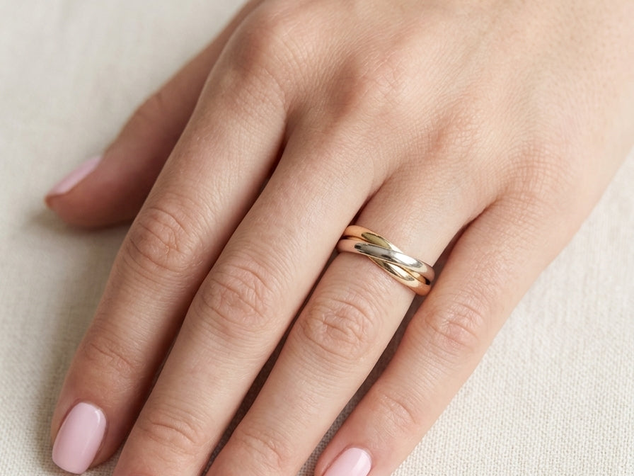 hand A three colour gold ring (AKA Russian wedding ring) Each band just under 3mm wide, D shape profile.
Yellow, white and rose gold,