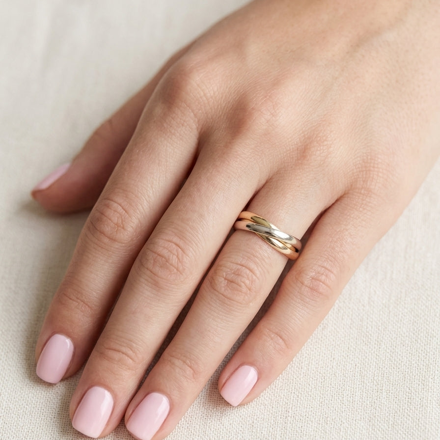 hand A three colour gold ring (AKA Russian wedding ring) Each band just under 3mm wide, D shape profile.
Yellow, white and rose gold,