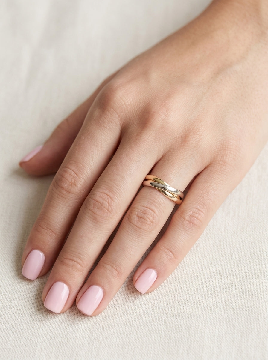 hand A three colour gold ring (AKA Russian wedding ring) Each band just under 3mm wide, D shape profile.
Yellow, white and rose gold,