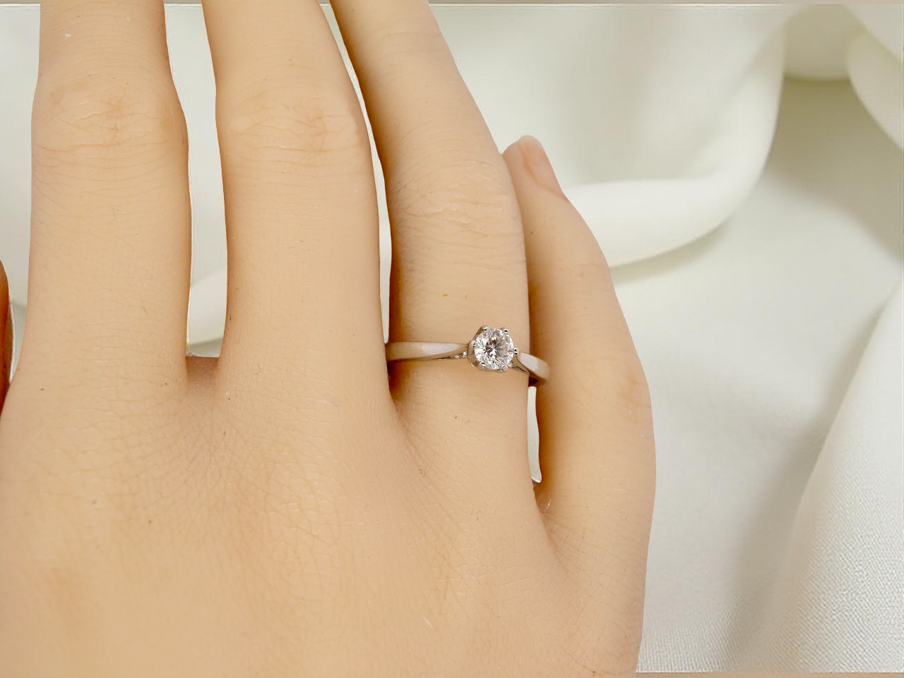 hand A timeless and elegant solitaire ring set with a brilliant-cut white diamond