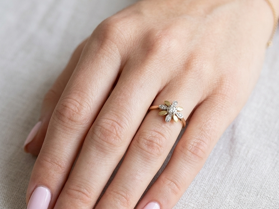 hand A very pretty cluster ring, a design from the 1950s. Its daisy style was popular during this period, and set with five small white diamonds (total est. 0.05 carats) set into platinum.