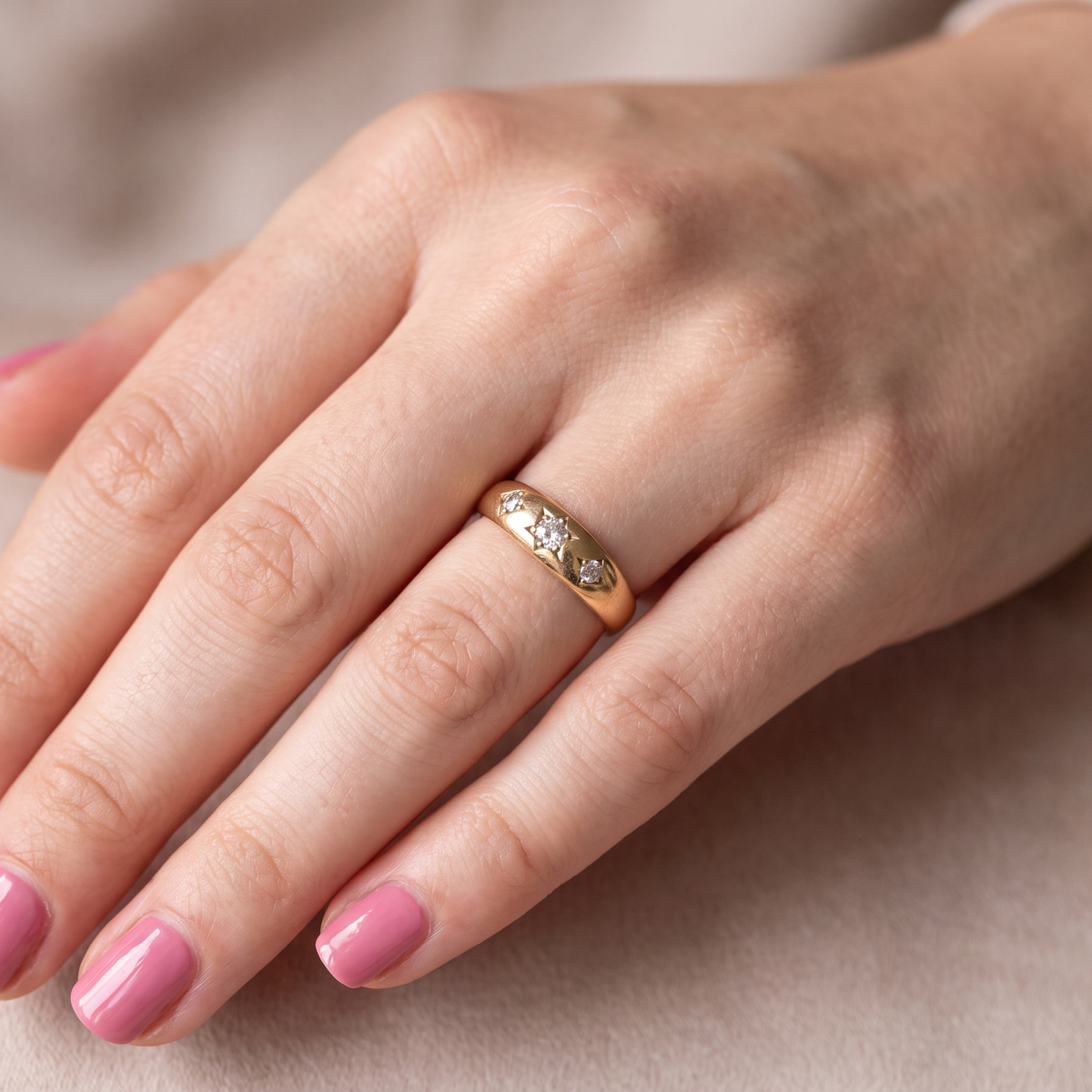 hand A vintage 18 carat gold three stone ring. Set with brilliant cut white diamonds, cente 3mm, each side a 2.4mm diamond (total est 0.20 carats) Colour I-j, clarity Si. 